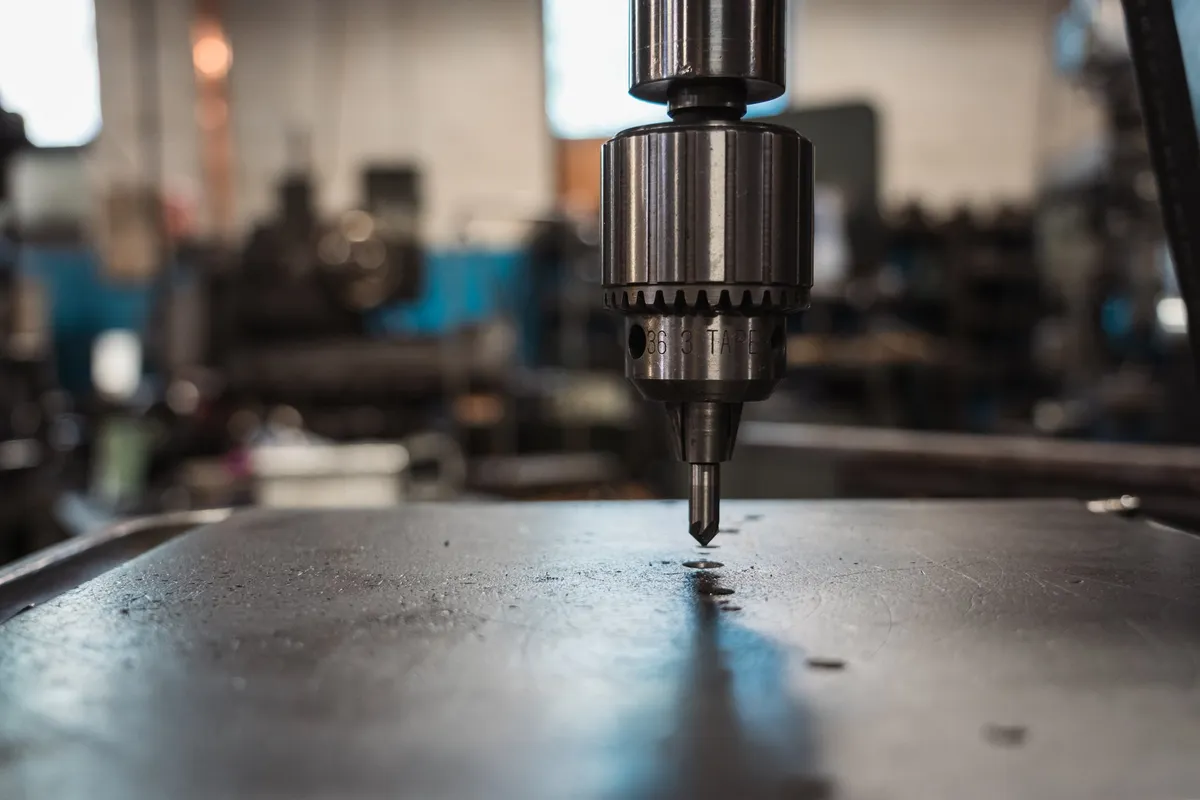 Drill press chuck over a steel bench
