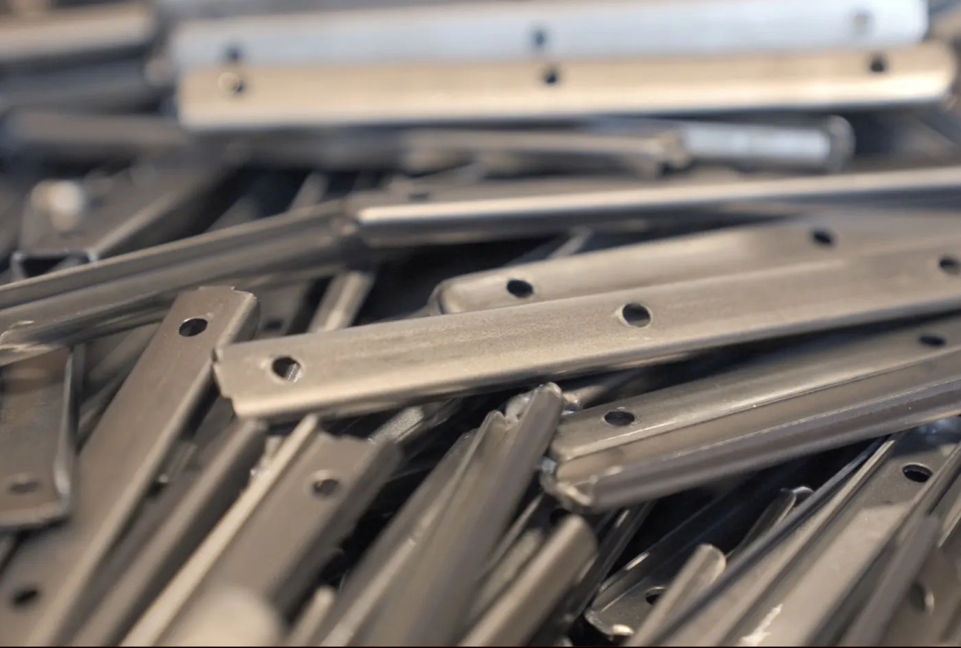 A bin of formed and punched steel brackets